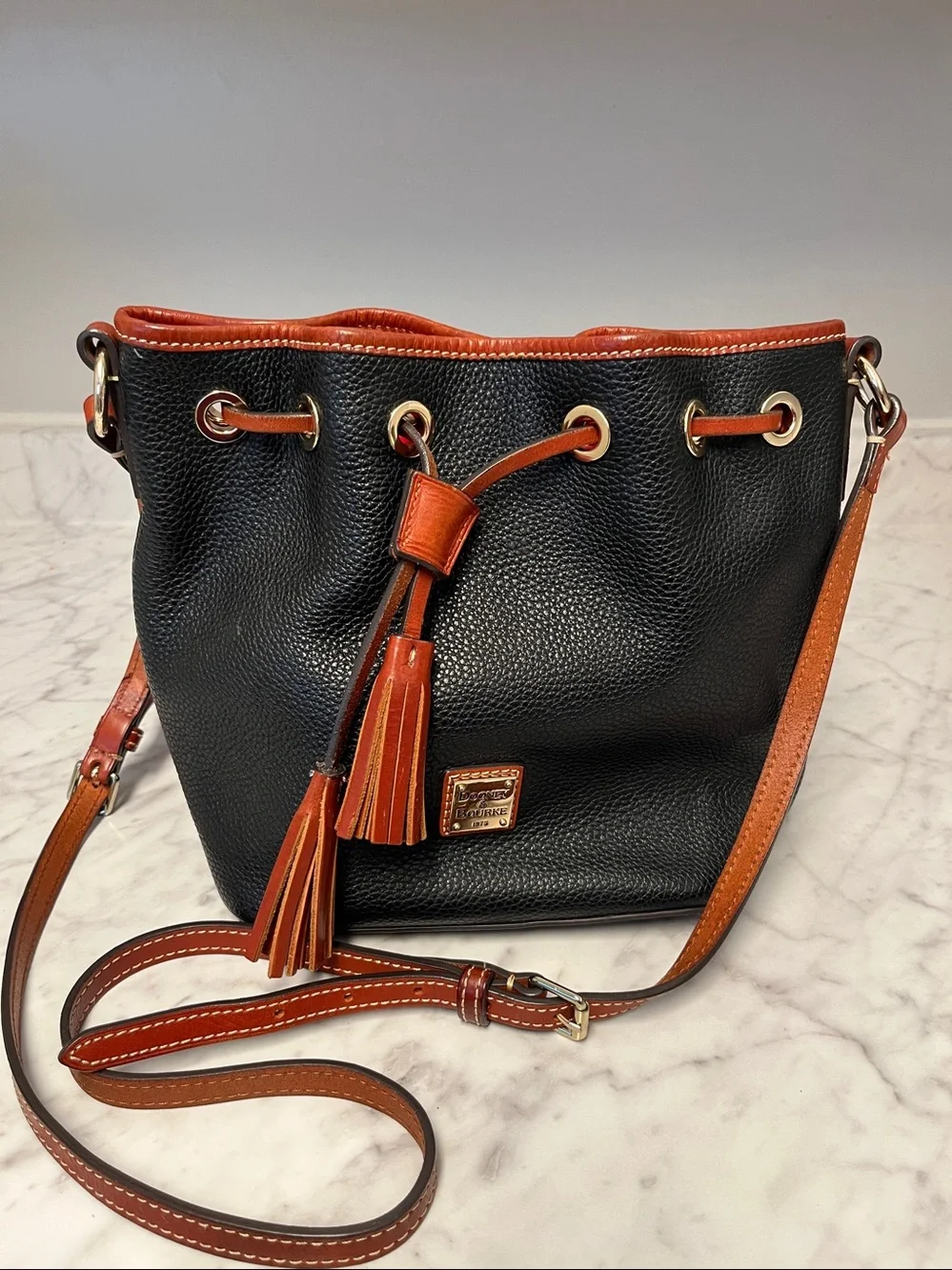 Dooney & Bourke Black Pebbled Leather Drawstring Crossbody with Brown Trim - Picture 1 of 3